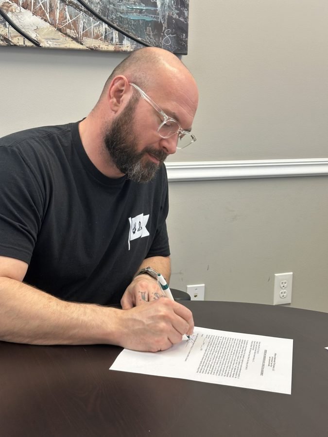 Seller with a giant key at a Kansas City closing