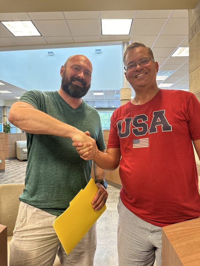 Seller holding a check after selling their house