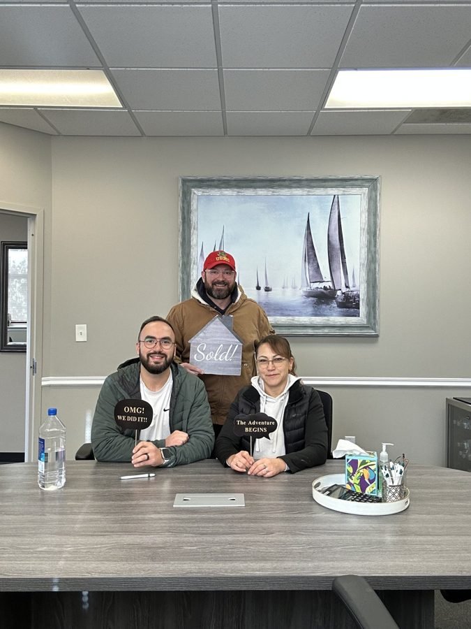 Homeowners at the closing table with a key
